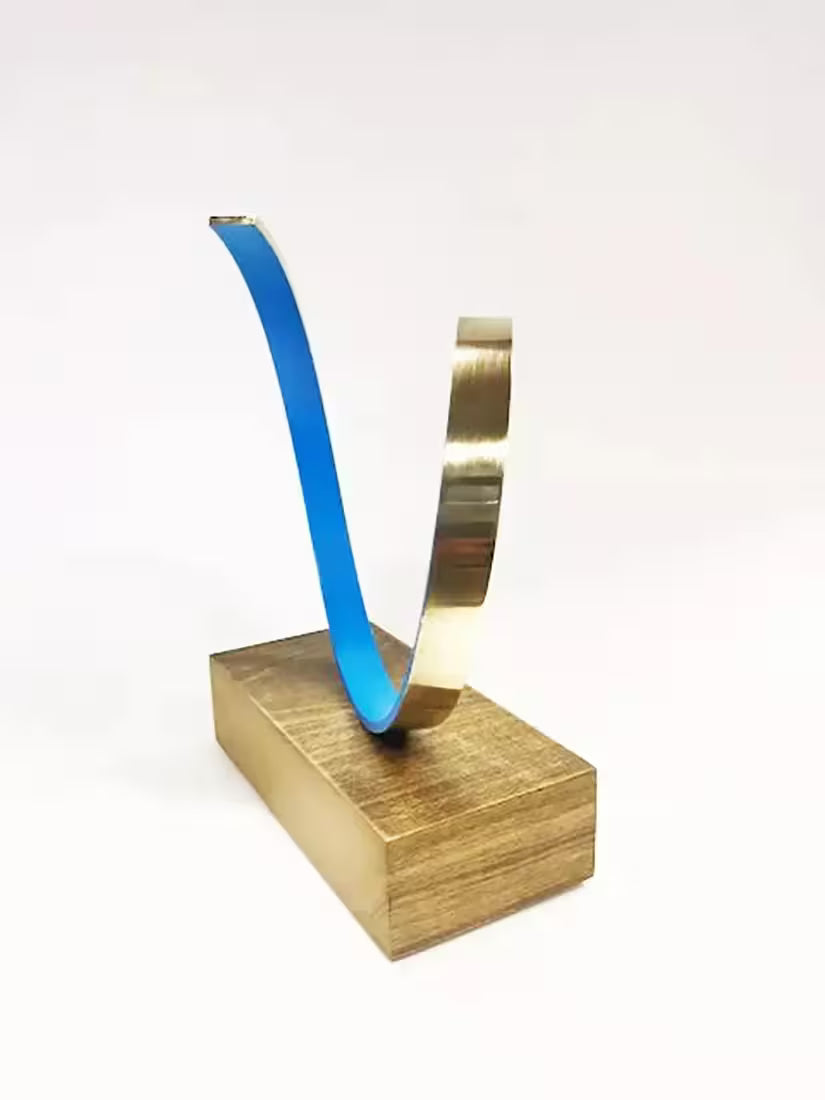 A Gareth Griffiths original sculpture of a blue spiral with a gold band around it, the title is La Onda