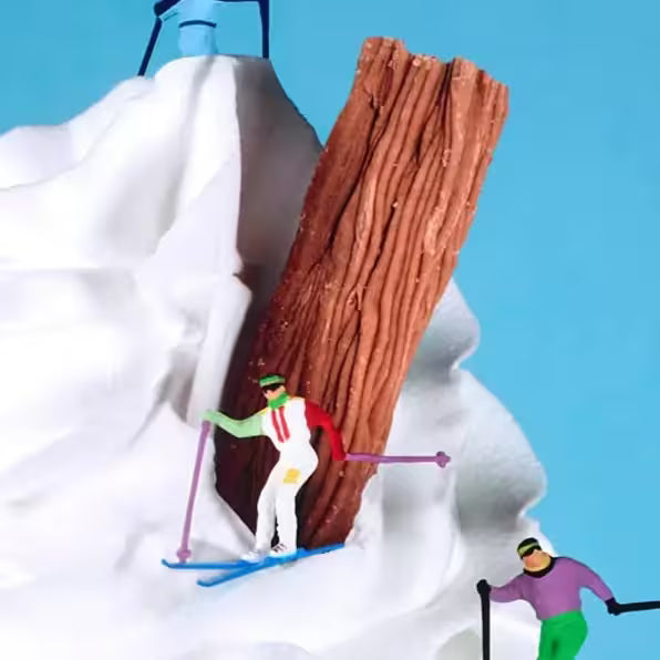 A Mr Kuu limited edition piece of a ice cream cone with people skiing down it, the title is Let&