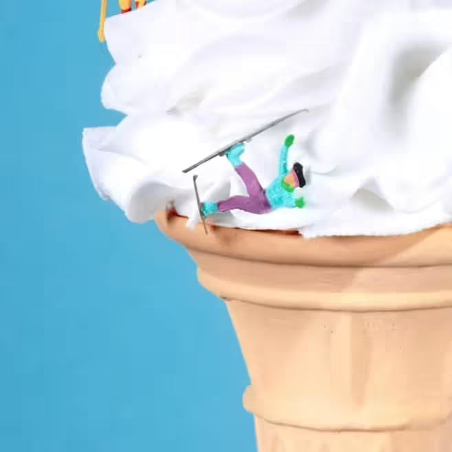 A Mr Kuu limited edition piece of a ice cream cone with people skiing down it, the title is Let&