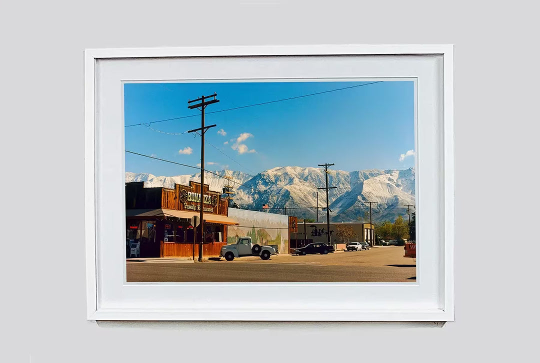A white framed limited edition photograph by Richard Heeps using vibrant colours, the title is Lone Pine, California, 2000