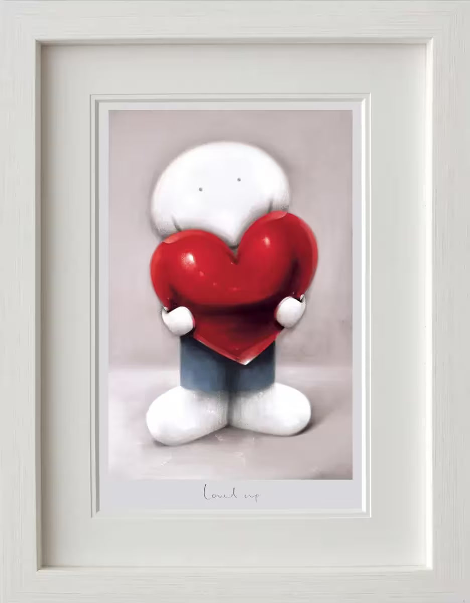 A Doug Hyde framed limited edition print of a person in blue holding a red heart, the title is Loved Up