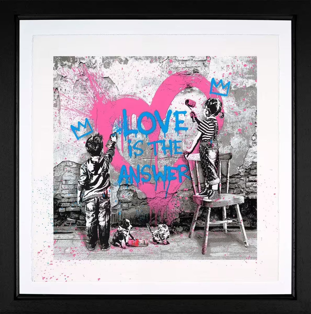 A Mr Brainwash framed limited edition of two children spray painting a pink heart on a wall with the words 'LOVE IS THE ANSWER' over the top with a puppy and kitten at the bottom, the title is Love Is The Answer