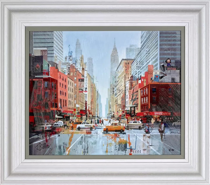 A Tom Butler framed limited edition print of Manhattan with lots of yellow cabs and cars driving through and the Empire State Building and Statue of Liberty in the background, the title is Manhattan Madness
