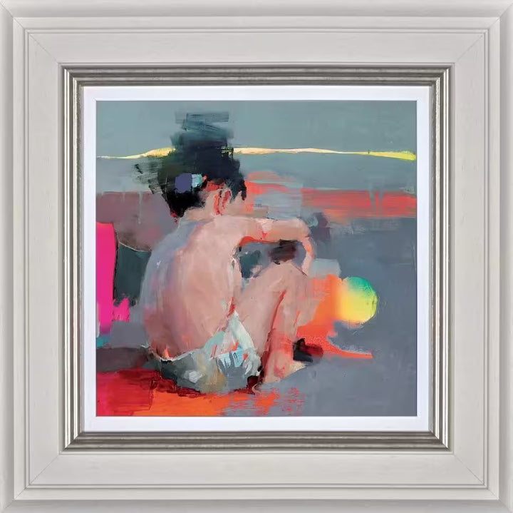A framed limited edition piece by Christian Hook of a small boy sat picking up an object distorted by bright colours, the title is Mar De Luces IV