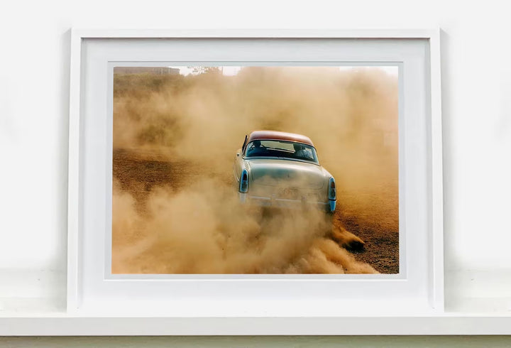 A white framed limited edition photograph by Richard Heeps using vibrant colours, the title is Mercury In The Dust, Hemsby, Norfolk, 2000