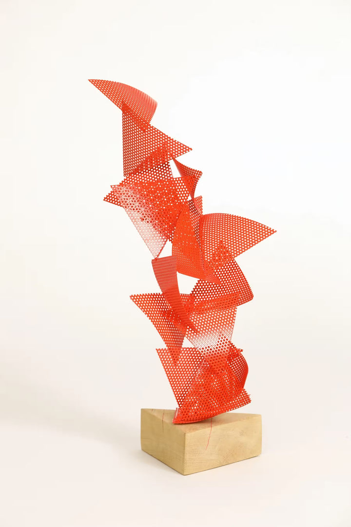 A Gareth Griffiths original sculpture of triangles with small holes arranged to make a geometric tower, the title is Mulholland
