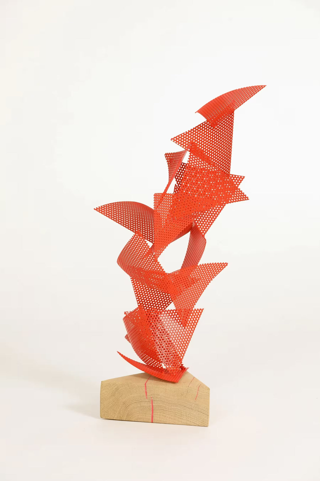 A Gareth Griffiths original sculpture of triangles with small holes arranged to make a geometric tower, the title is Mulholland