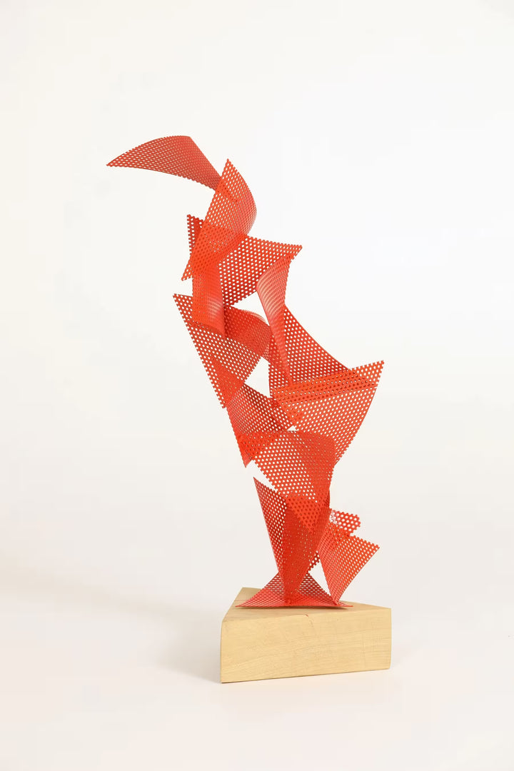 A Gareth Griffiths original sculpture of triangles with small holes arranged to make a geometric tower, the title is Mulholland