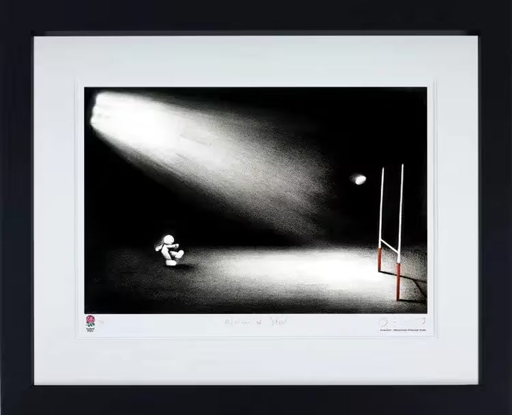 A Doug Hyde framed limited edition print of a rugby player kicking a ball over a goal post and a ray of light shining down, the title is Nerves of Steel