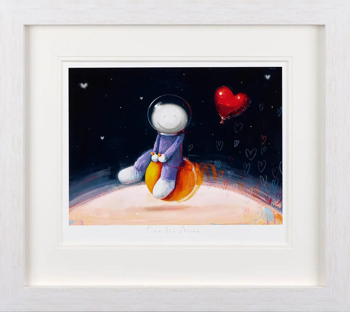 Over the Moon by Doug Hyde, presented in a white frame, depicts an image of a spaceman riding a space hopper with hearts trailing behind available from Startle