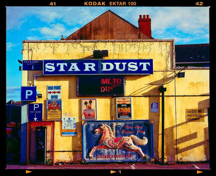 A limited edition photograph by Richard Heeps using vibrant colours, the title is Pleasure Park, Barry Island, 2023