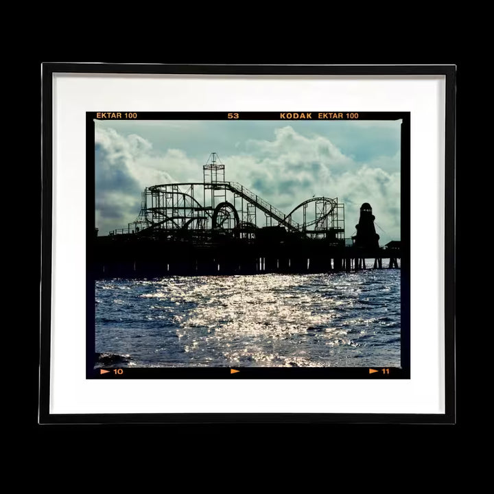 A framed limited edition photograph by Richard Heeps using vibrant colours, the title is Pleasure Pier, Clacton-On-Sea, 2021