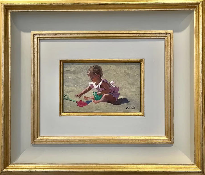 A Sherree Valentine Daines framed original of a blonde baby with a pink swim set on playing in the sand, the title is Pretty in Pink