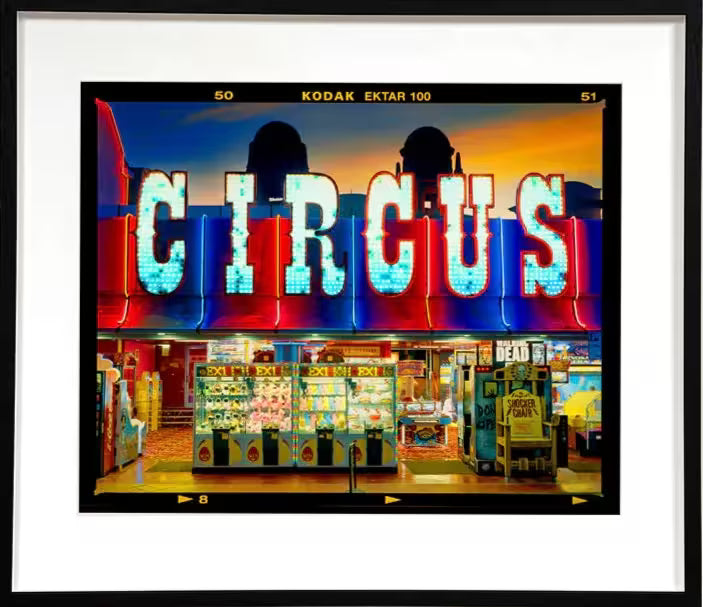A framed limited edition photograph by Richard Heeps using vibrant colours, the title is Prize Shop, Norfolk, 2022