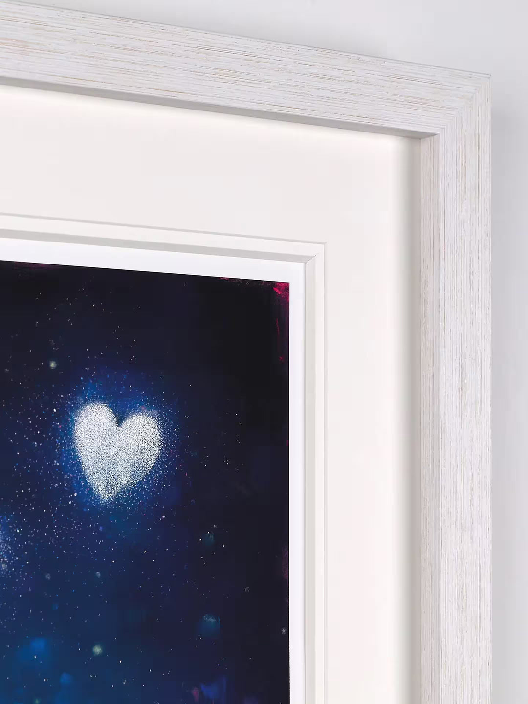 A Doug Hyde limited edition of a person letting go of glowing dust in the shape of a heart, the title is Pure Magic