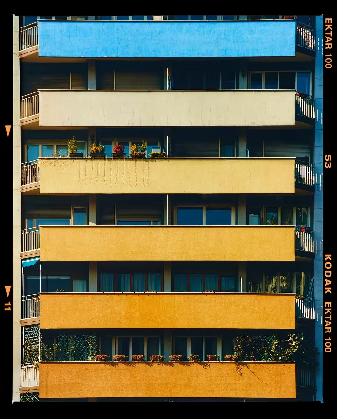 A limited edition photograph by Richard Heeps using vibrant colours, the title is Rainbow Apartments (Film Rebate), Milan, 2020