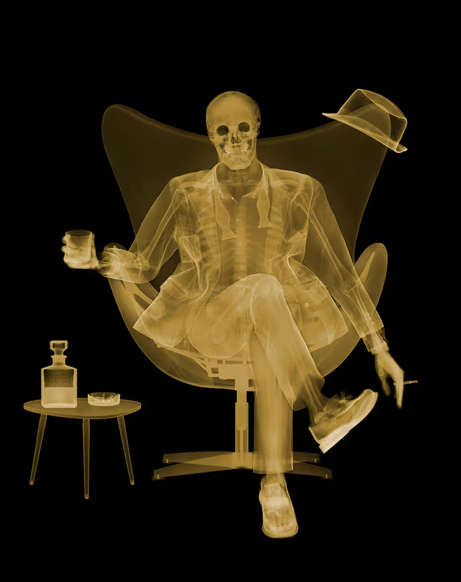 A Nick Veasey limited edition Chromaluxe Xray of a person sat drinking and smoking, the title is Rat Pack III- Golden Era