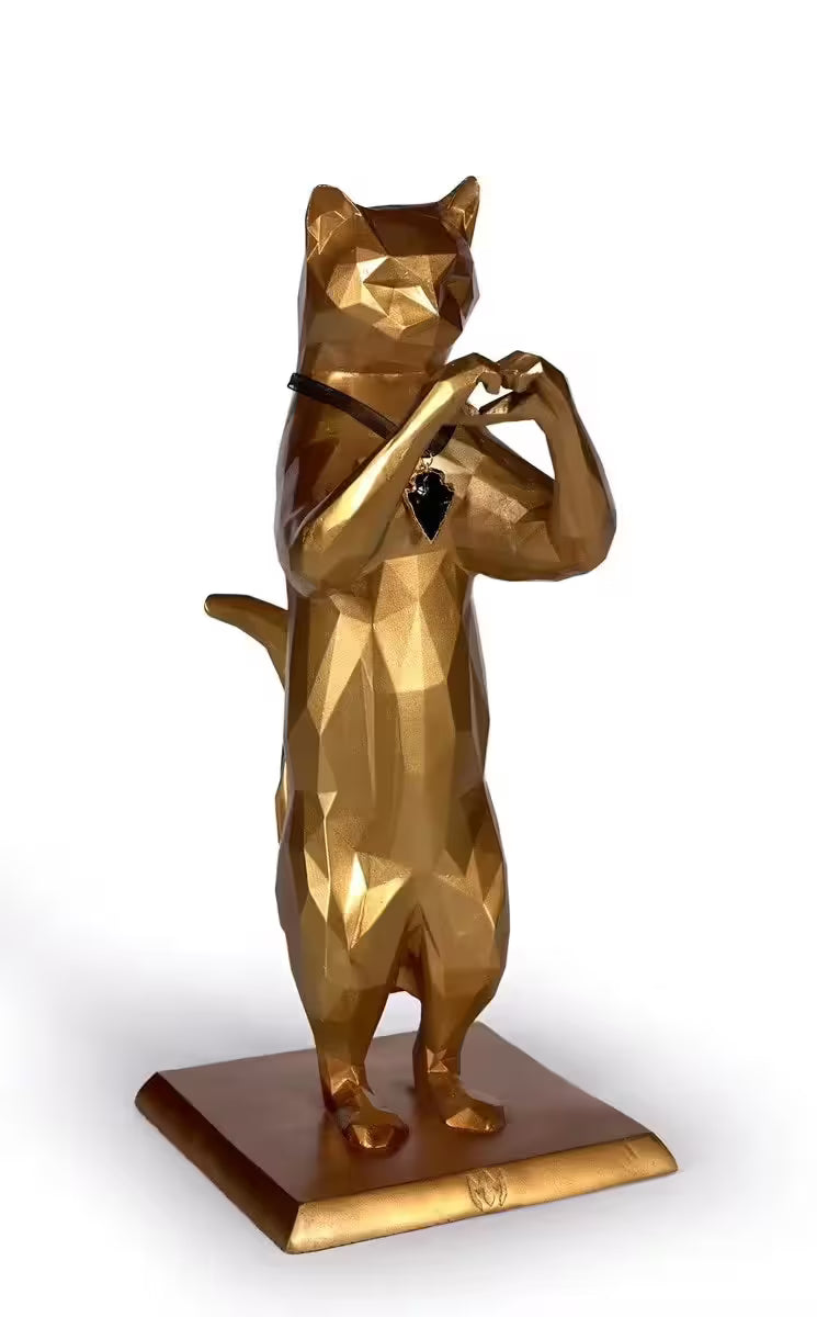 A Maxim limited edition sculpture of a gold geometric cat making a love heart, the title is Rebel Love