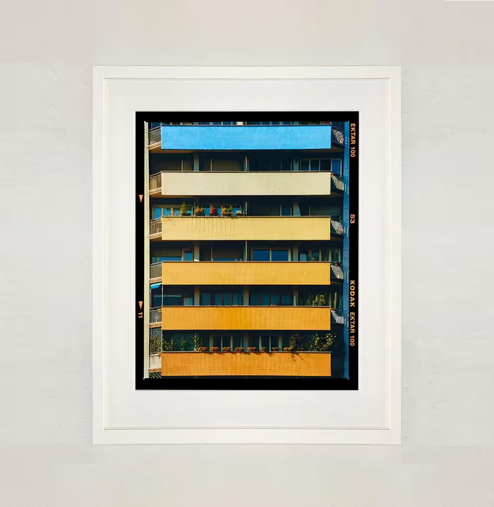 A framed limited edition photograph by Richard Heeps using vibrant colours, the title is Rainbow Apartments (Film Rebate), Milan, 2020