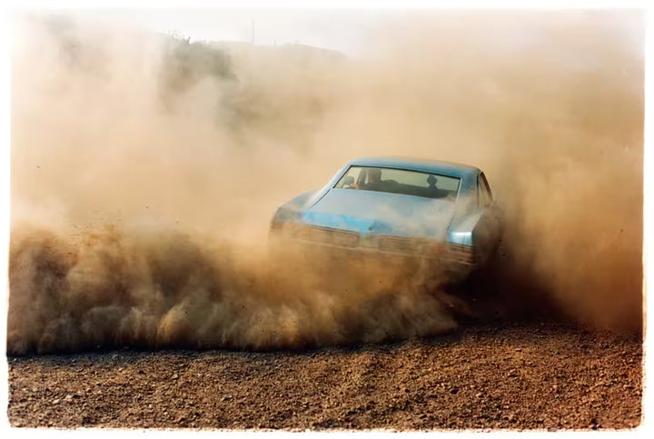 A limited edition photograph by Richard Heeps using vibrant colours, the title is Buick In The Dust III, Hemsby, Norfolk, 2000