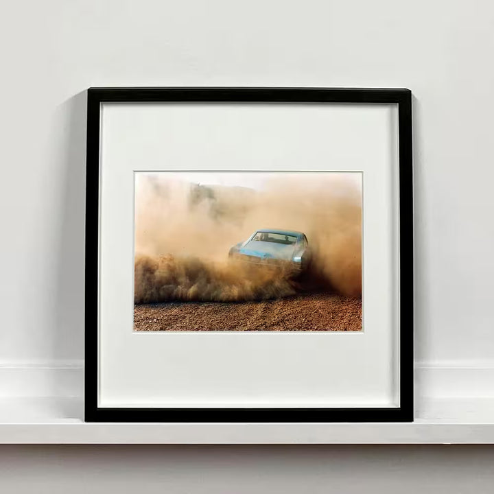 A framed limited edition photograph by Richard Heeps using vibrant colours, the title is Buick In The Dust III, Hemsby, Norfolk, 2000