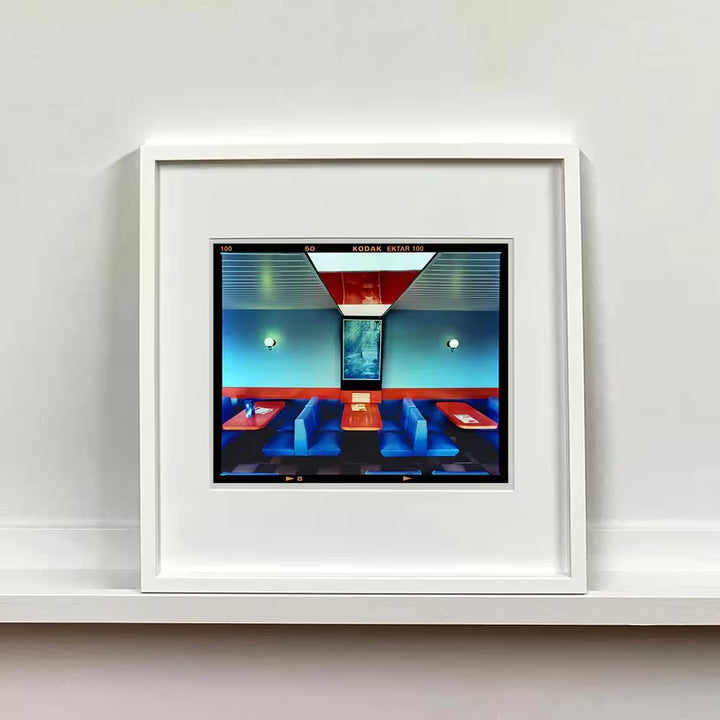 A white framed limited edition photograph by Richard Heeps using vibrant colours, the title is Vintage Wimpy, Norfolk, 2023