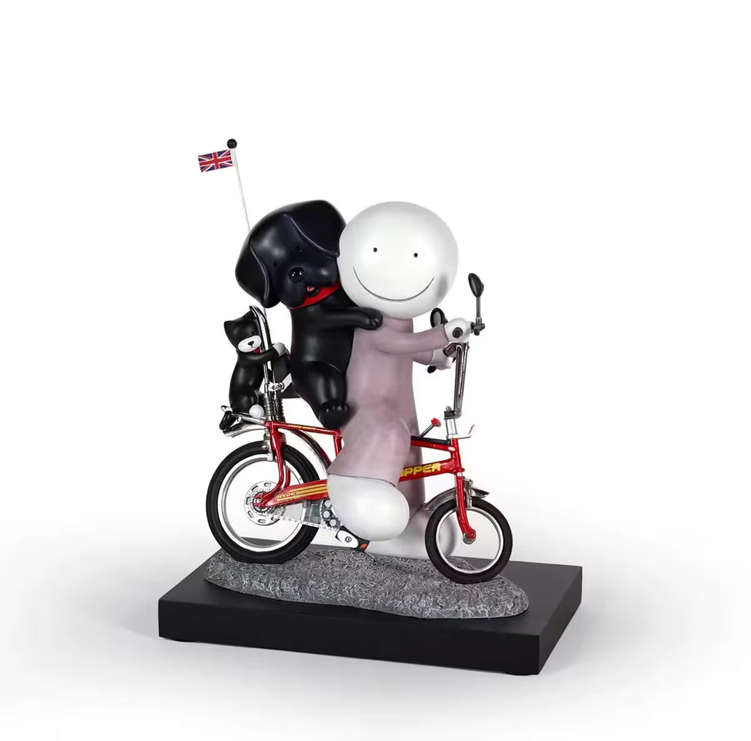 A sculpture by Doug Hyde of a person in purple on a red bike with a black dog on their back and a black cat holding onto the bike, the title is Riding High