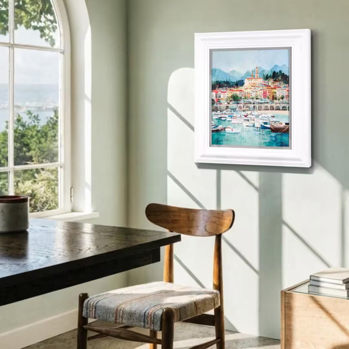 A Tom Butler limited edition of a riviera with boats and bright buildings, the title is Riviera Way