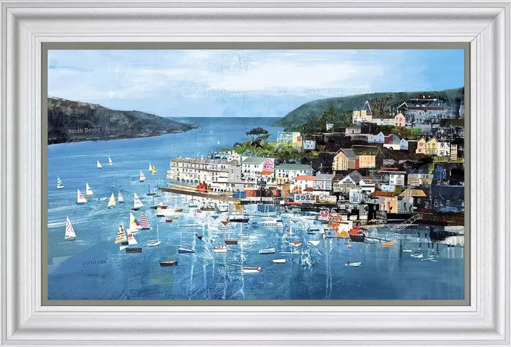 A Tom Butler framed limited edition collage of Salcombe, it shows the coastline with lots of sailing boats scattered across and buildings behind, the title is Salcombe Sails
