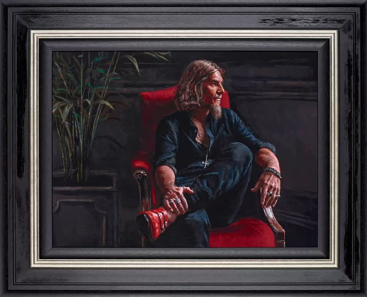 A Fabian Perez framed limited edition self portrait piece of Fabian sat on a red chair, the title is Self Portrait: 20 Years in Reflection