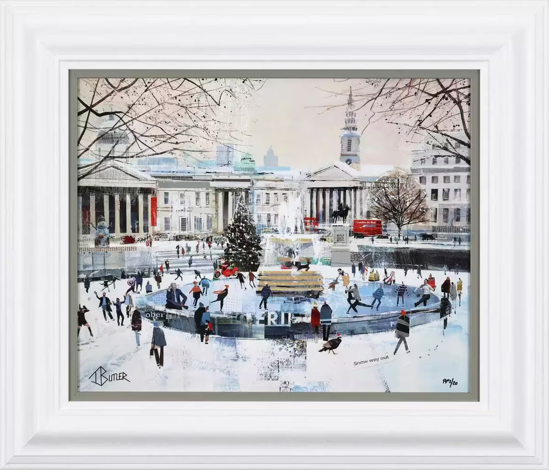 A Tom Butler framed limited edition collage of Trafalgar Square in the snow with ice skaters on a rink and people walking around, the title is Snow Motion