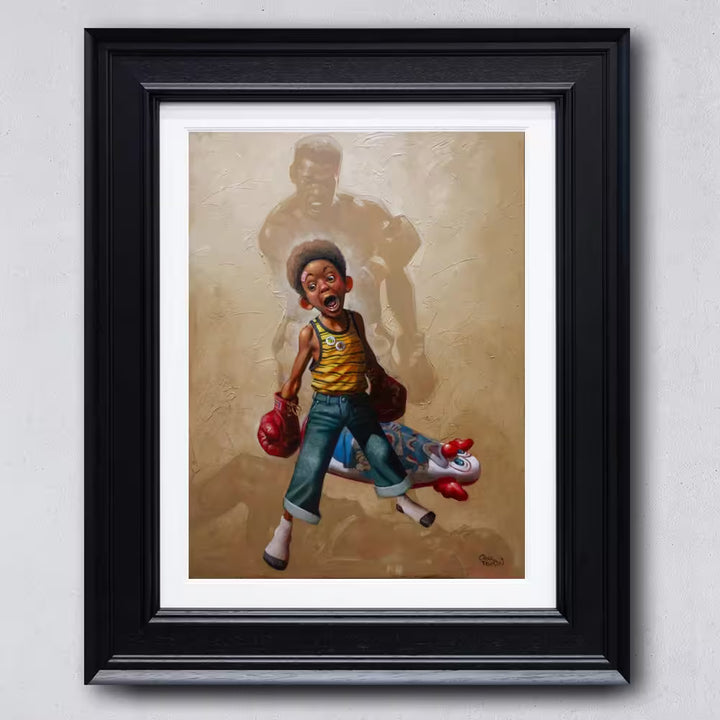 A Craig Davison limited edition of a young boy with boxing gloves on and has knocked down a n inflatable clown, the title is Sting Like a Bee