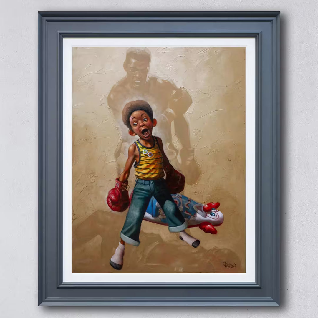 A Craig Davison limited edition of a young boy with boxing gloves on and has knocked down a n inflatable clown, the title is Sting Like a Bee
