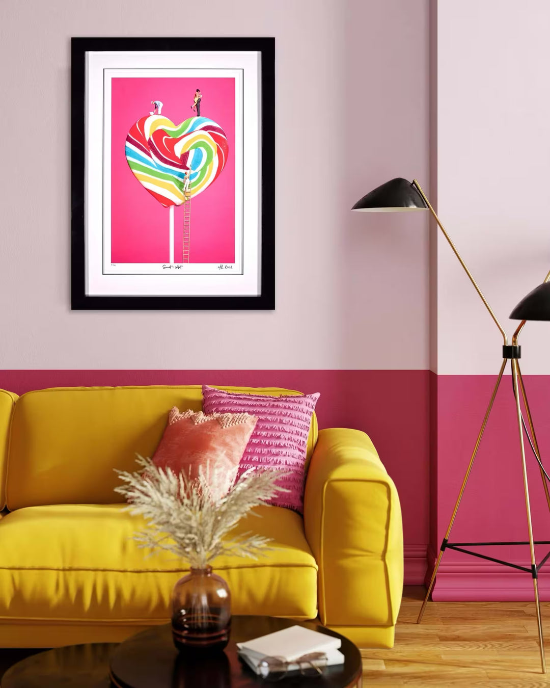 A Mr Kuu limited edition piece of a heart shaped lollipop with people painting the stripes and a couple on top, the title is Sweet Art