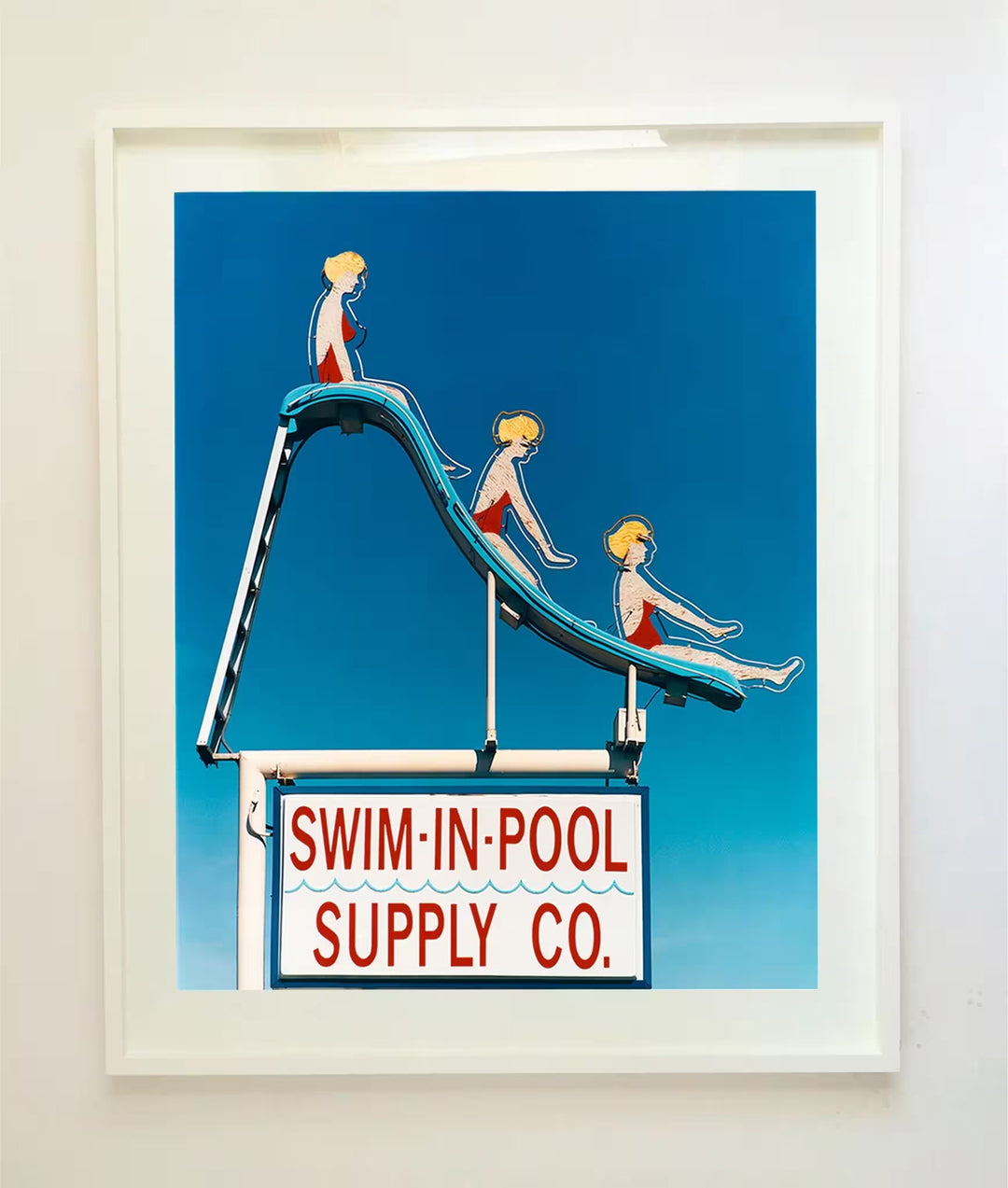 A white framed limited edition photograph by Richard Heeps using vibrant colours, the title is Swim-in-Pool Supply Co. Las Vegas, 2003