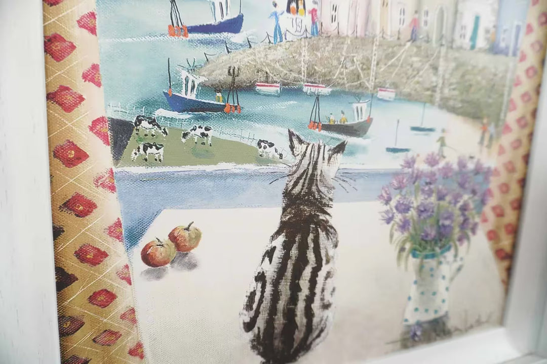 A Rebecca Lardner limited edition of a seaside town with boats, cows and people and a cat sat on a table looking down, the title is Table Manners