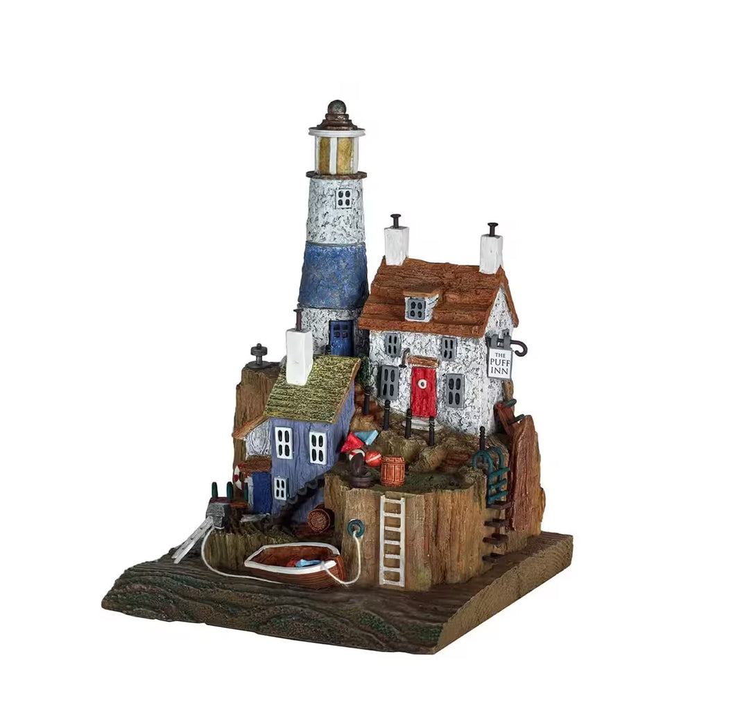 A Rebecca Lardner limited edition sculpture of some seaside buildings clustered together, the title is The Puff Inn