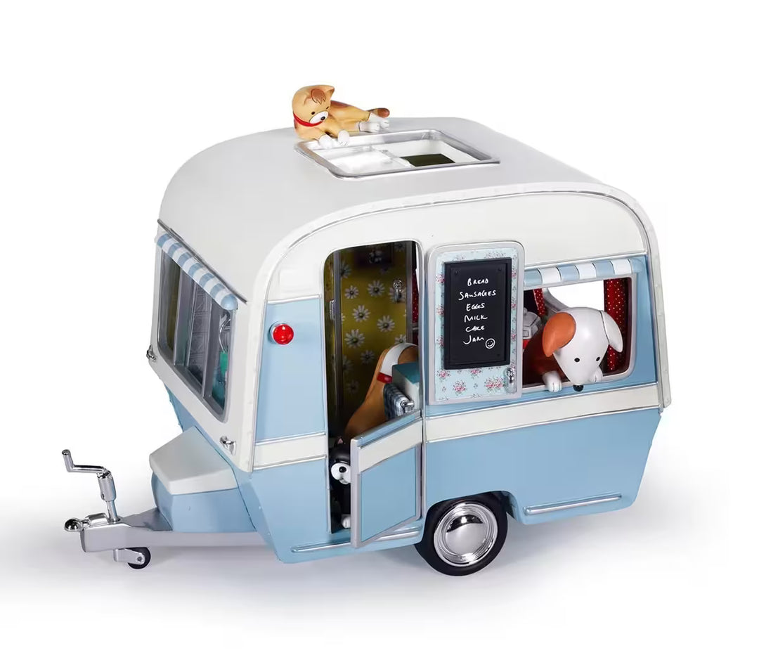 A sculpture by Doug Hyde of a caravan with two dogs inside and a cat laying on the top, the title is The Great Escape