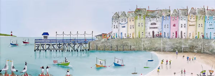 A Rebecca Lardner limited edition piece of a row of colourful houses with a pier at the end and people on the beach and boats on the sea with puffins, seagulls, and avocets on the rocks, the title is Tide and Seek