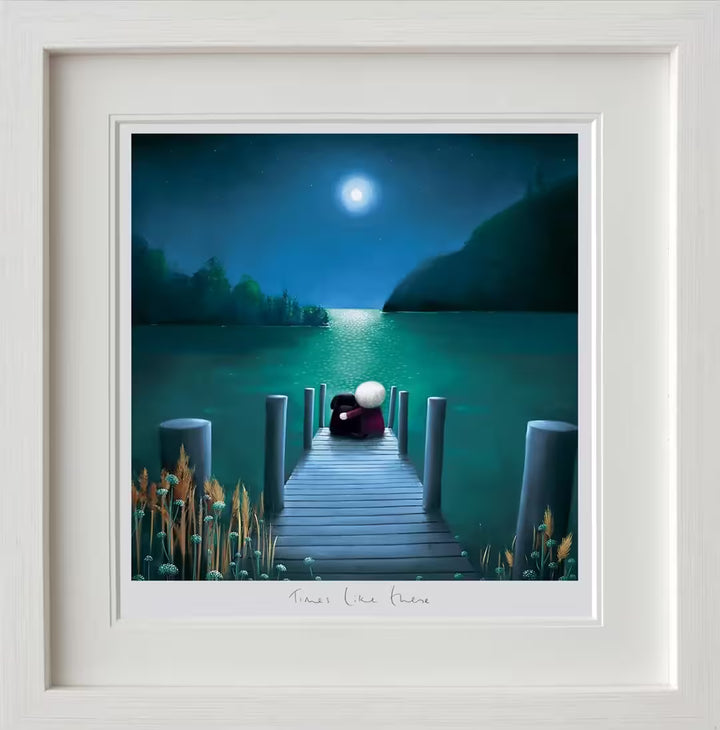 A Doug Hyde framed limited edition of a person with their arm around a black dog sat in front of a lake and the moon is up shining over them, the title is Times Like These