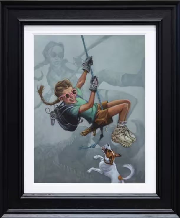 A Craig Davison limited edition of a girl swinging on a rope with her dog jumping up to bite her with Lara Croft in the background, the title is Tomb Me, Tomb You
