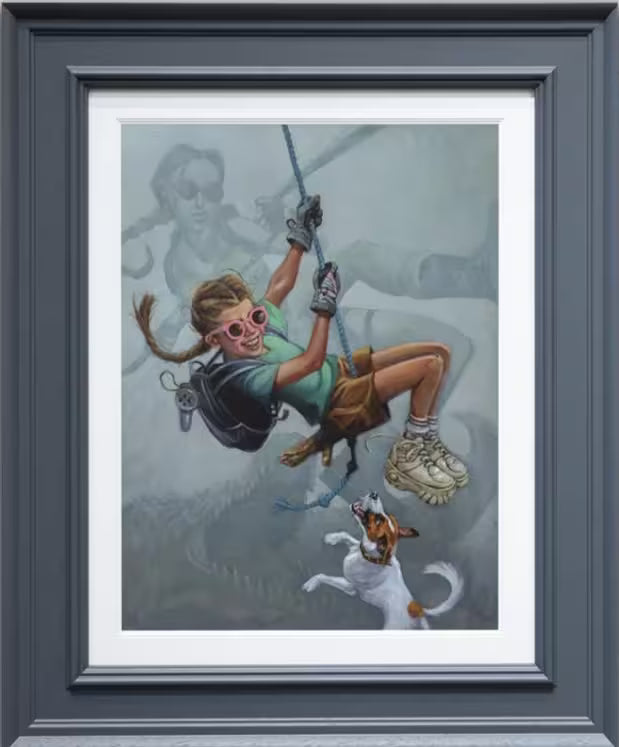 A Craig Davison limited edition of a girl swinging on a rope with her dog jumping up to bite her with Lara Croft in the background, the title is Tomb Me, Tomb You
