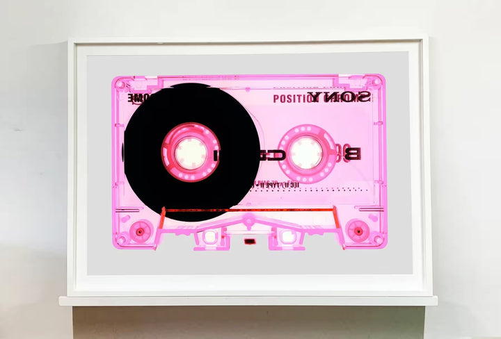A white framed limited edition photograph by Richard Heeps using vibrant colours, the title is Tape Collection Type II Pink