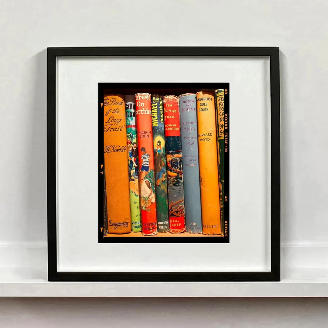 A framed limited edition photograph by Richard Heeps using vibrant colours, the title is Wanderlust Goes South, Peter's Bookshop, Sheringham, 2018