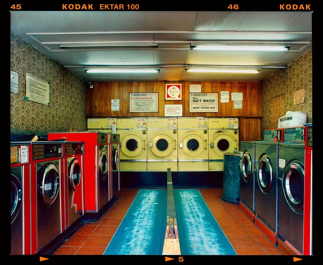 A limited edition photograph by Richard Heeps using vibrant colours, the title is Washeteria- Looking In, London, 2020
