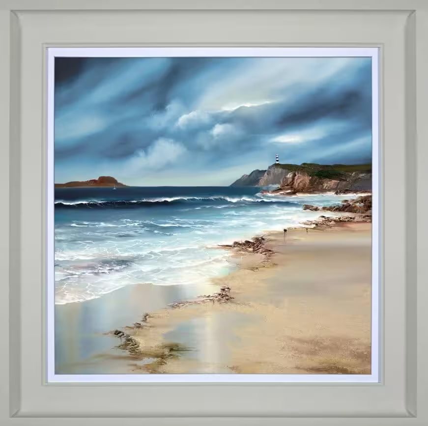A Philip Gray framed limited edition of a calm shoreline looking over a lighthouse and some dark clouds, the title is Whispering Tides