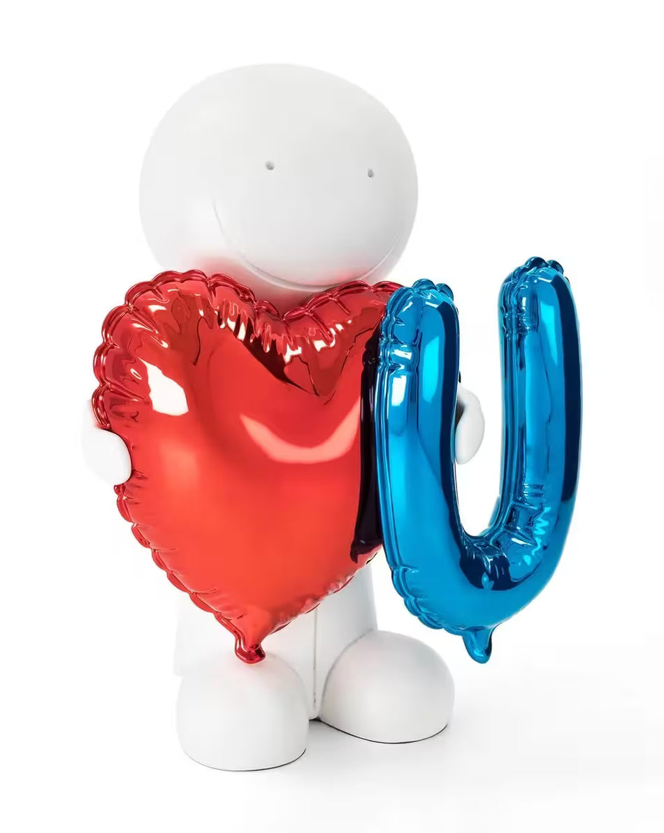 A sculpture by Doug Hyde of a person holding a red heart balloon and a blue balloon of the letter 'U', the title is You Have My Heart