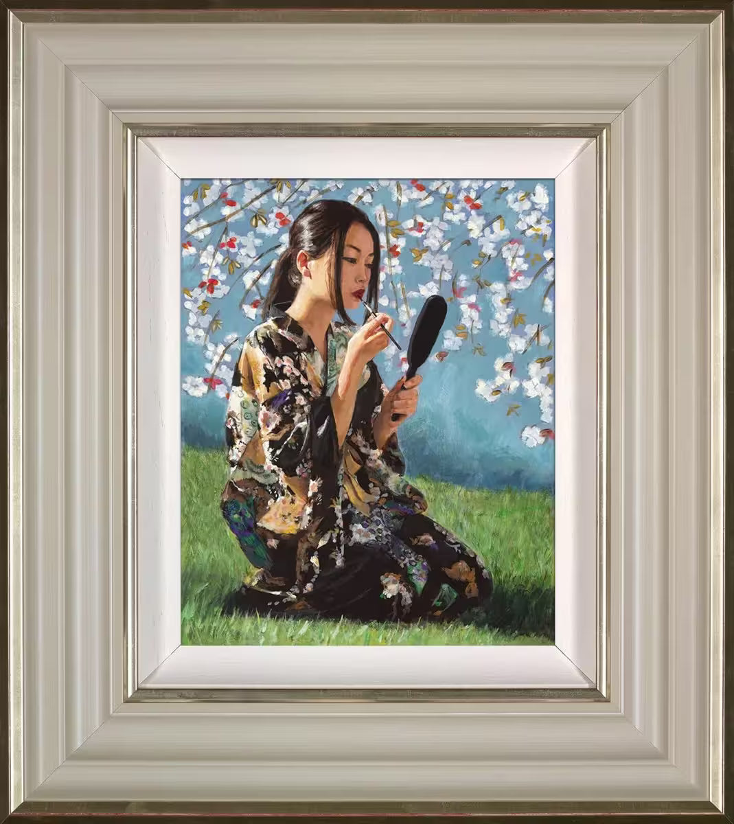 A Fabian Perez framed limited edition piece of a geisha sat under a blossoming tree applying lipstick, the title is Geisha With White Flowers II