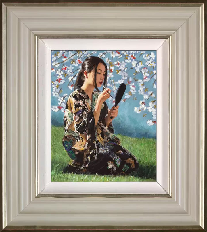 A Fabian Perez framed limited edition piece of a geisha sat under a blossoming tree applying lipstick, the title is Geisha With White Flowers II