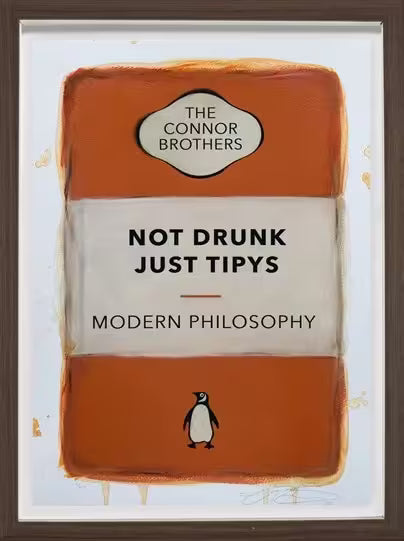 A limited edition framed print by The Connor Brothers of a penguin book cover with a witty line across the front, the title is Not Drunk Just Tipys (Orange)